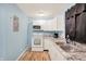 Efficient kitchen with new countertops, white cabinetry, and modern appliances at 524 S Arlington Ave, Indianapolis, IN 46219