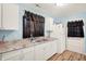 Clean kitchen with white cabinets, neutral counter tops and an adjacent door at 524 S Arlington Ave, Indianapolis, IN 46219