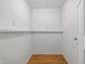 Small storage room with a shelf in the basement at 5503 Antoneli Ln, Indianapolis, IN 46237