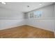 The basement features painted walls, a window, and wood-look floors at 5503 Antoneli Ln, Indianapolis, IN 46237