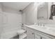 Bright bathroom featuring a shower-tub combo and a vanity with a marble countertop at 5503 Antoneli Ln, Indianapolis, IN 46237