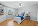 Comfortable bedroom featuring a ceiling fan, bright windows, and hardwood floors at 5503 Antoneli Ln, Indianapolis, IN 46237