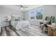 Stylized bedroom with a ceiling fan, hardwood floors, and abundant natural light at 5503 Antoneli Ln, Indianapolis, IN 46237