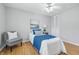 Cozy bedroom with bright window, a ceiling fan, and hardwood floors at 5503 Antoneli Ln, Indianapolis, IN 46237