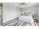 Neutral bedroom with large closet, ceiling fan, stylish decor and hardwood flooring at 5503 Antoneli Ln, Indianapolis, IN 46237