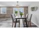 Inviting dining room with a table for four, modern lighting, and a view to the outside at 5503 Antoneli Ln, Indianapolis, IN 46237