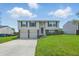 Charming two-story home with a well-manicured lawn, double garage, and blue shuttered windows at 5503 Antoneli Ln, Indianapolis, IN 46237