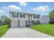 Charming two-story home with a two-car garage, steps to the front door, and a well-manicured lawn at 5503 Antoneli Ln, Indianapolis, IN 46237