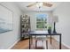 Bright office featuring hardwood floors, minimal decor, and a stylish furniture set at 5503 Antoneli Ln, Indianapolis, IN 46237