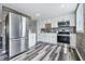 Modern kitchen with stainless steel appliances, white cabinetry, and elegant countertops at 5503 Antoneli Ln, Indianapolis, IN 46237