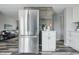Modern kitchen featuring stainless steel refrigerator, white cabinets and drawers at 5503 Antoneli Ln, Indianapolis, IN 46237
