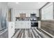 Modern kitchen with stainless steel appliances, white cabinetry, and elegant countertops at 5503 Antoneli Ln, Indianapolis, IN 46237