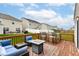 Inviting outdoor deck featuring comfortable seating, a fire pit, and an outdoor bar, ideal for relaxation and social gatherings at 5775 Bluff View Ln, Whitestown, IN 46075
