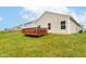 Spacious backyard featuring a wooden deck, green lawn, and fenced yard, offering a private outdoor space for leisure at 5775 Bluff View Ln, Whitestown, IN 46075