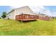 Expansive backyard featuring a wooden deck, lush lawn, and fenced perimeter, perfect for outdoor relaxation and entertainment at 5775 Bluff View Ln, Whitestown, IN 46075