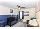 Cozy bedroom featuring a wooden crib, blue wall paneling, and a themed decor, perfect for a room at 5775 Bluff View Ln, Whitestown, IN 46075