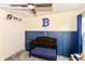 Charming bedroom showcasing a wooden crib against blue wall paneling, creating a warm and inviting space for a  at 5775 Bluff View Ln, Whitestown, IN 46075