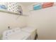 Functional laundry room with a washer, dryer, and storage shelves, maximizing space and efficiency for household chores at 5775 Bluff View Ln, Whitestown, IN 46075