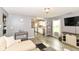 Bright living room featuring modern flooring, natural light, and an open layout to the kitchen at 5775 Bluff View Ln, Whitestown, IN 46075