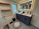 Modern bathroom with dual sinks, sleek cabinetry, and illuminated mirror at 5786 N Delaware St, Indianapolis, IN 46220