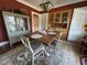 Dining room with hardwood floors, china cabinet, and seating for four at 5786 N Delaware St, Indianapolis, IN 46220