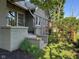 Exterior view featuring a side porch and a beautifully landscaped yard at 5786 N Delaware St, Indianapolis, IN 46220
