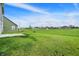 Spacious backyard featuring lush lawn and a view of the surrounding neighborhood at 5812 Flat Hill Dr, Indianapolis, IN 46239