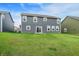 Well-maintained backyard featuring lush lawn and a view of the home's rear exterior at 5812 Flat Hill Dr, Indianapolis, IN 46239