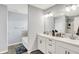 Bright bathroom featuring a double sink vanity with white cabinets and a bathtub at 5812 Flat Hill Dr, Indianapolis, IN 46239