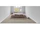 A clean-designed bedroom with plush carpet, a full sized bed, and a sunny window for natural lighting at 5812 Flat Hill Dr, Indianapolis, IN 46239
