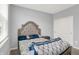 Cozy bedroom featuring a decorative headboard and a sunlit window, creating a relaxing ambiance at 5812 Flat Hill Dr, Indianapolis, IN 46239