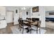 Cozy dining area with a wood table set adjacent to the fireplace and living room at 5812 Flat Hill Dr, Indianapolis, IN 46239