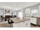 Open kitchen and dining area featuring a kitchen island with bar seating and stainless steel appliances at 5812 Flat Hill Dr, Indianapolis, IN 46239