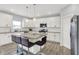 Bright kitchen with white cabinetry, a breakfast island, and stainless steel appliances at 5812 Flat Hill Dr, Indianapolis, IN 46239