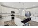 Well-lit kitchen with white cabinetry, stainless steel appliances, and a breakfast island with seating at 5812 Flat Hill Dr, Indianapolis, IN 46239