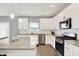 Well-lit kitchen featuring stainless steel appliances, granite countertops, and sleek white cabinets at 5812 Flat Hill Dr, Indianapolis, IN 46239