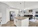 Modern kitchen with granite countertops, stainless steel appliances, and a breakfast island at 5812 Flat Hill Dr, Indianapolis, IN 46239