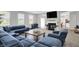 Open-concept living room with a fireplace, flat screen tv, and a blue sectional sofa at 5812 Flat Hill Dr, Indianapolis, IN 46239