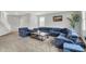 Comfortable living room featuring a plush blue sectional sofa and a stylish coffee table at 5812 Flat Hill Dr, Indianapolis, IN 46239
