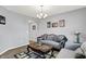 Comfortable living room featuring gray walls, hardwood floors, elegant sofas, coffee table, and decor creating a welcoming space at 5812 Flat Hill Dr, Indianapolis, IN 46239