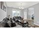 Cozy living room with neutral walls, dark wood floors, tufted sofas, decorative pillows, and natural light from a window at 5812 Flat Hill Dr, Indianapolis, IN 46239