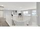 Open and airy loft area with a staircase and railing showcasing natural light and modern design at 5812 Flat Hill Dr, Indianapolis, IN 46239