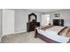 The main bedroom offers a serene retreat with neutral walls, a dresser, and an access door at 5812 Flat Hill Dr, Indianapolis, IN 46239