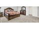 Spacious main bedroom with a carpeted floor, decorative bedding, and dark wood furniture at 5812 Flat Hill Dr, Indianapolis, IN 46239