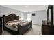 Spacious main bedroom featuring plush carpets, a large bed, and a dresser with a mirror for ample storage at 5812 Flat Hill Dr, Indianapolis, IN 46239