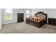 Bright main bedroom with a carpeted floor, decorative bedding, and dark wood furniture at 5812 Flat Hill Dr, Indianapolis, IN 46239