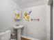 Small bathroom with pedestal sink, elongated toilet, and colorful wall decor at 590 W Washington St, Martinsville, IN 46151