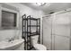 Full bath features glass shower enclosure, decorative shelving, and white vanity at 590 W Washington St, Martinsville, IN 46151