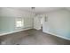 Comfortable bedroom featuring neutral carpet, trim and paint, and natural light from the window at 590 W Washington St, Martinsville, IN 46151