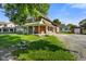 Charming brick home with a covered front porch and landscaped yard on a sunny day at 590 W Washington St, Martinsville, IN 46151